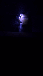 Looping clip of a hand-built high-voltage device sparking with a bright blue-white arc in a dark room.